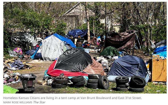 A dense tent encampment with discarded tires